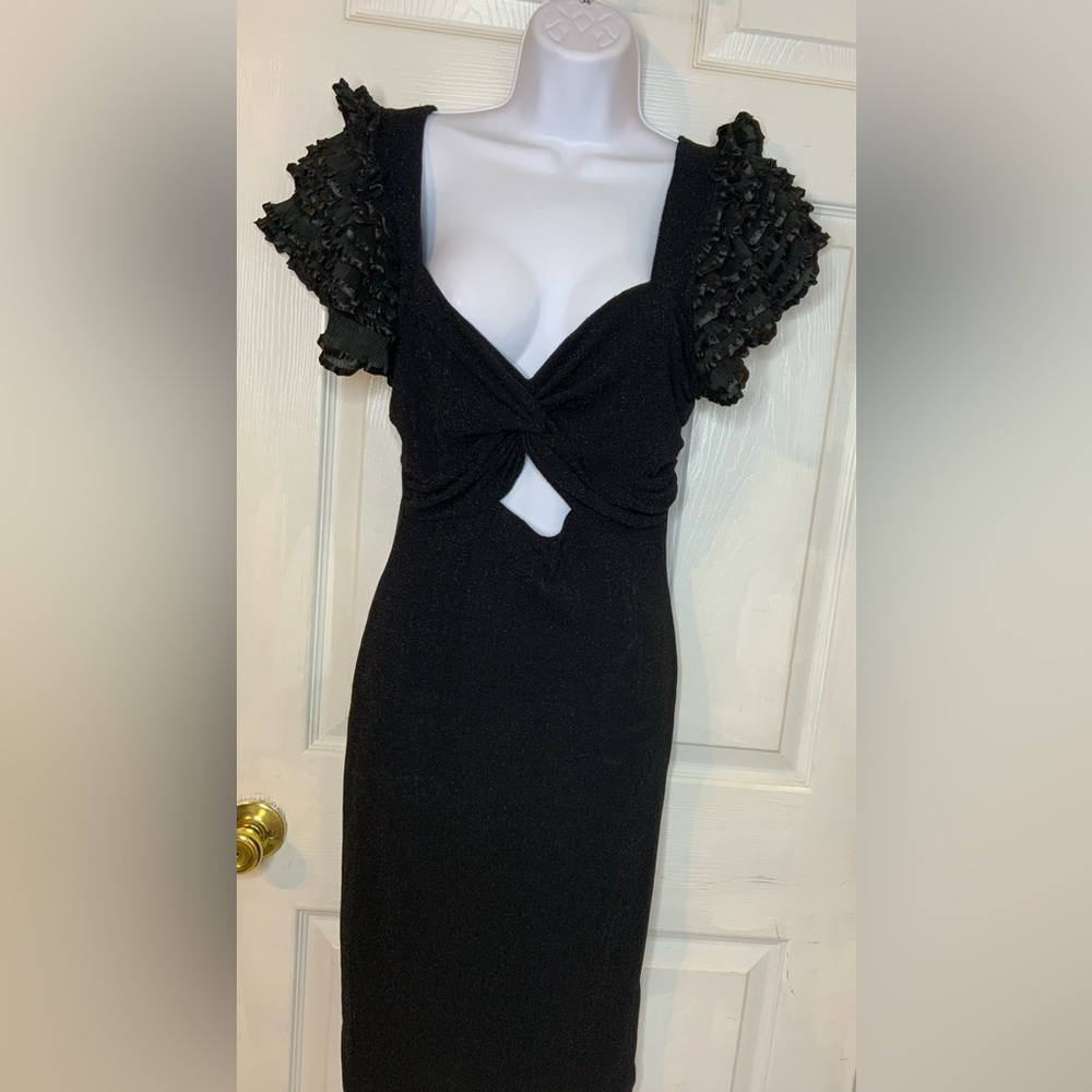 Women’s black dress with a keyhole cutout and stretch fabric.